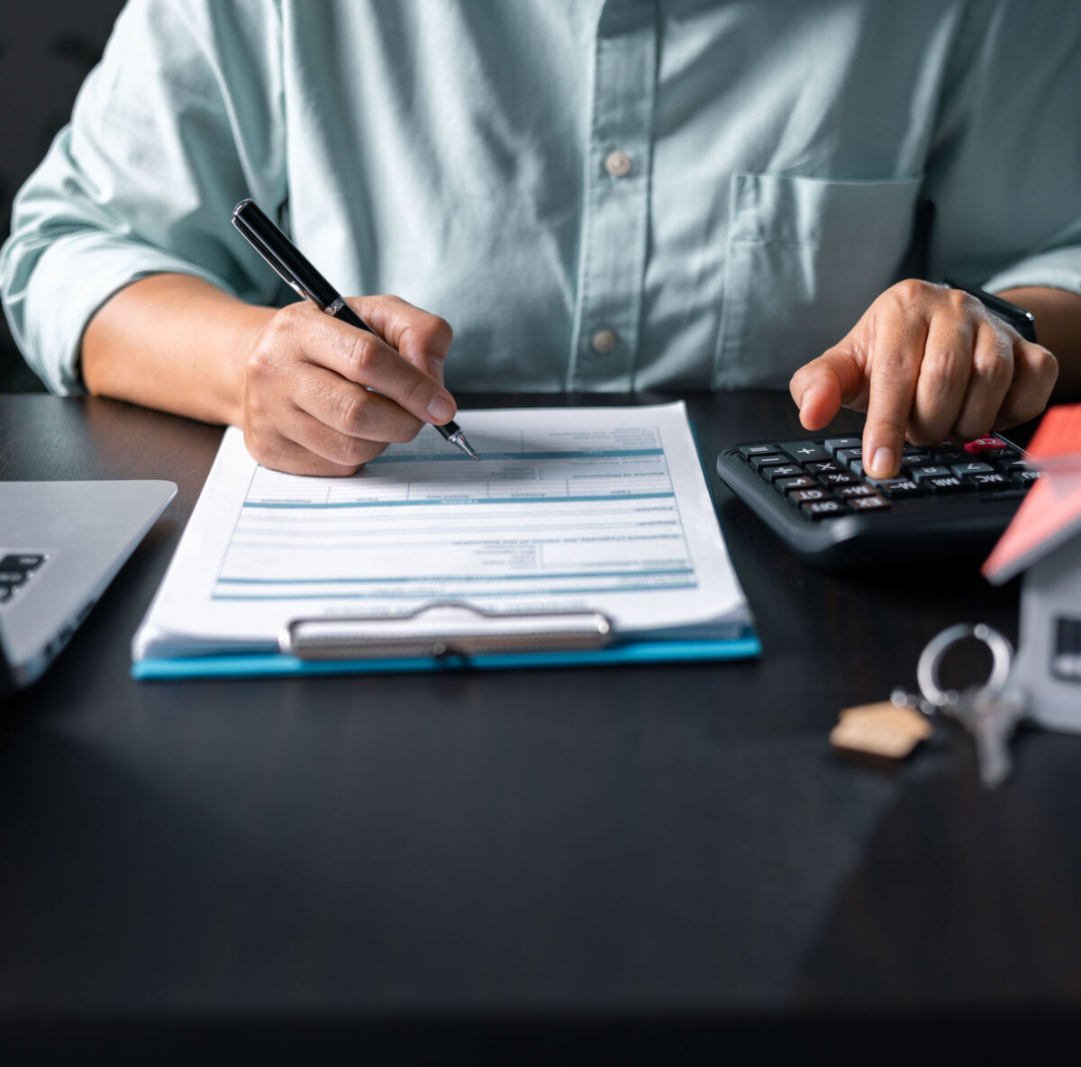 Did you know HMRC can investigate your VAT returns at short notice? Image of someone using a calculator and filling in a form. Did you know HMRC can investigate your VAT returns at short notice?