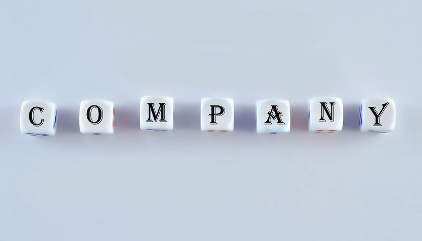 An image of white dice with letters spelling out the word COMPANY, to illustrate an article on company disincorporation.