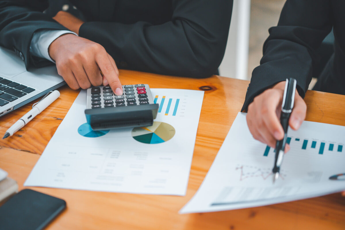 Image of tax return accountants working on financial figures with a calculator