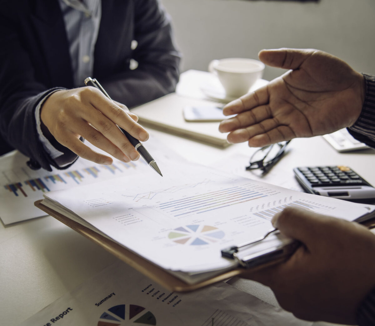 THP's grant audit service keeps admin to a minimum. An image of two people working together on financial information.