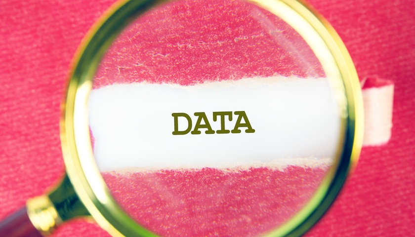 An image of a magnifying glass held over the word DATA, to accompany an article on HMRC data matching.