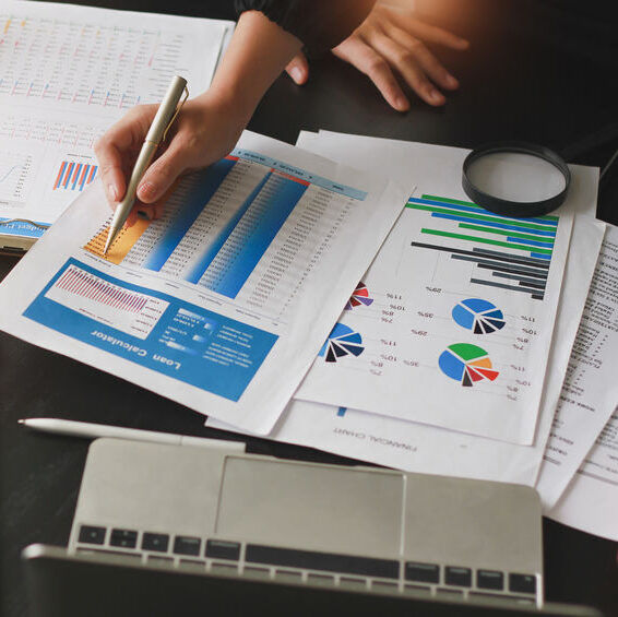 THP offers an outsourced Financial Director service as well as management accounts. An image of someone working on figures and pie charts. They have a magnifying glass. This accompanies a section about outsourcing your Financial Director role to an accountancy firm that also provides management accounts.