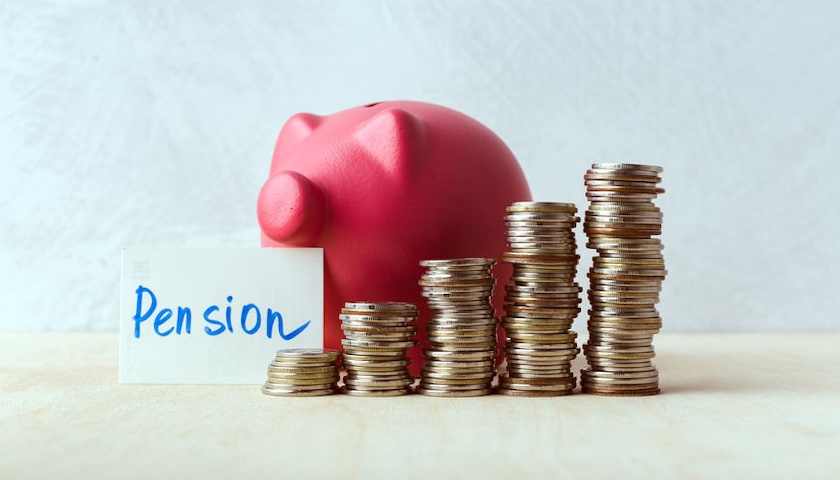 Photo of a piggy bank next to coins and a sign that reads 'PENSION' to illustrate an article on salary sacrifice pension changes.