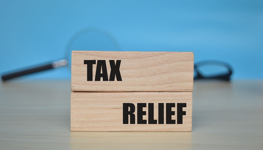The words TAX RELIEF written on two wooden blocks, illustrating an article on the 2026 First Year Allowance.
