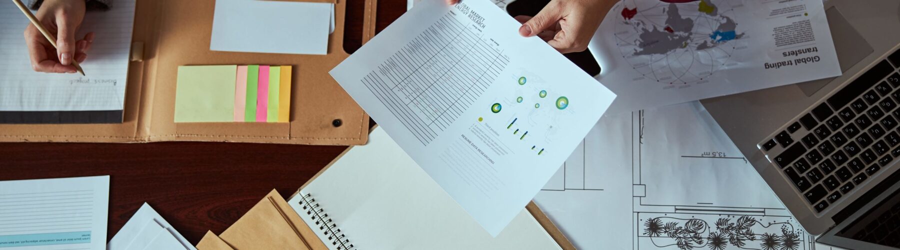 Image of two people working on business papers, illustrating an article on R&D grant funding from Innovate UK for UK businesses