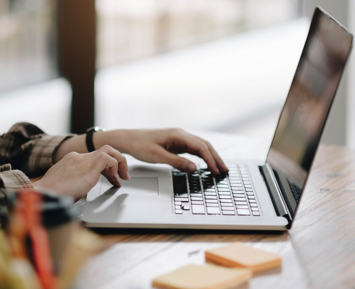 FreeAgent can solve MTD for sole traders Image of someone using a laptop - MTD for sole traders requires compatible software