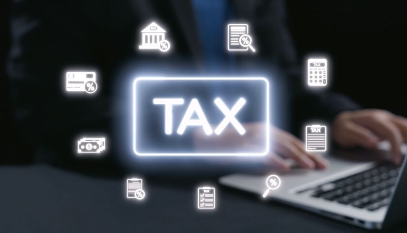 A digital collage based around the word TAX, illustrating an article on MTD quarterly reporting