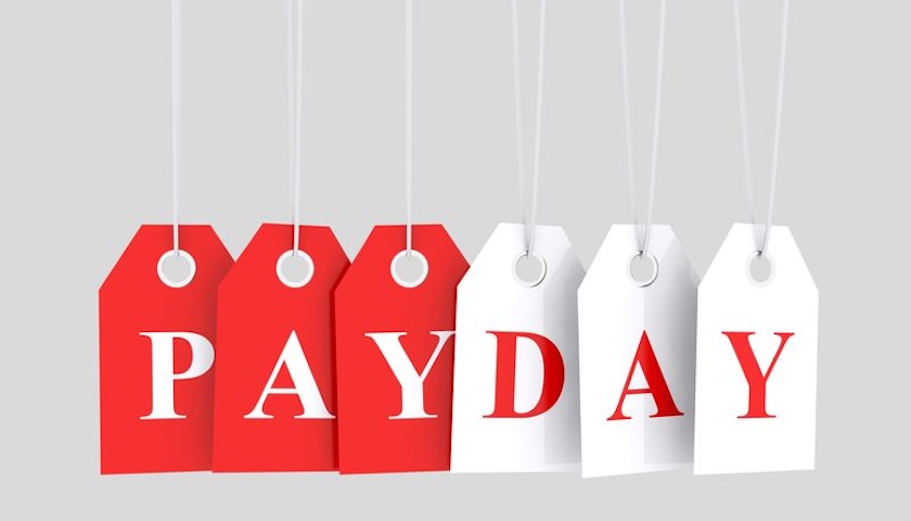 Hanging labels that spell out the word payday - to illustrate an article on how to pay yourself from a limited company