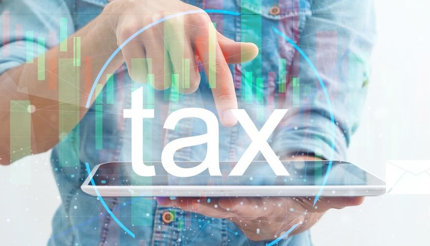 An image for someone using a tablet with the word 'tax' superimposed on it, to illustrate an article on missing the first Making Tax Digital outline
