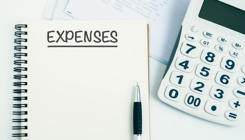 An image of a notepad, pan and calculator. The notepad has the word EXPENSES written on it. The image illustrates an article on missing receipts for business expenses and what to do about them.