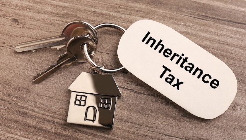 A keyring with a house shaped fob and another with the words Inheritance Tax on it, illustrating an article on inheritance tax for unmarried couples
